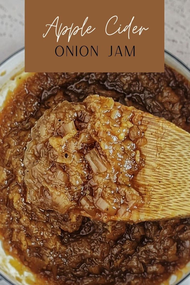 an apple cider onion jam in a bowl with a wooden spoon