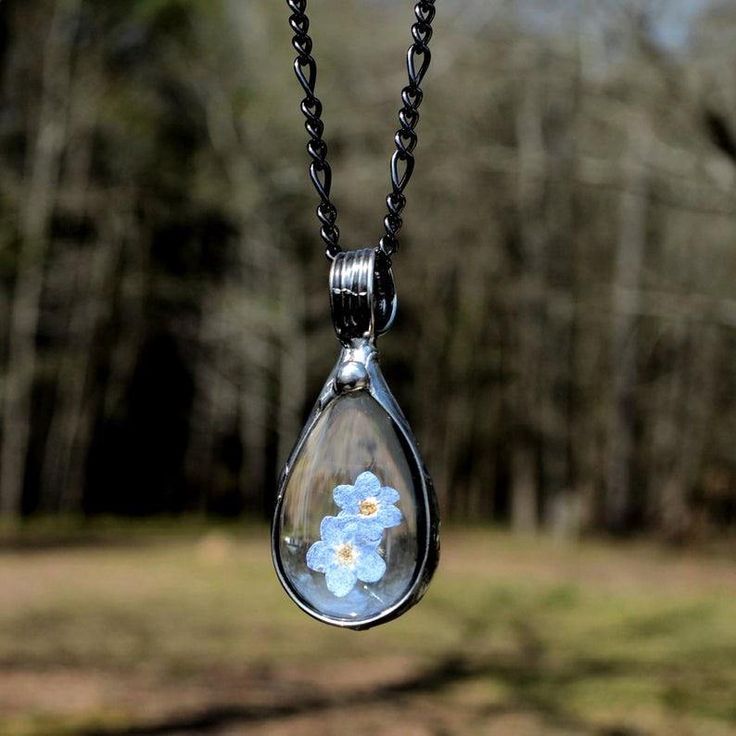 Bayou Glass Arts Forget Me Not Pendant 1 3/4"H x 3/4"W (44mm x 19mm) Truly Hand Made in USA FREE 1st Class Domestic Shipping This listing is qualifies for next day shipping Expedited shipping available Your choice of 22", 24" or long 28" fully adjustable figaro chain. Gift Wrapping and Messaging available Choose from Shiny Black Gunmetal Finish or Shiny Silver Finish Style #2783 Real Pressed Flower Jewelry A Forget Me Not, lovely blue flower dry pressed handmade necklace for woman and special oc Bff Necklace, Pressed Flower Jewelry, Teardrop Jewelry, Forget Me Not Flower, Bff Necklaces, Figaro Chain, Flower Jewelry, Necklace Blue, Pressed Flower