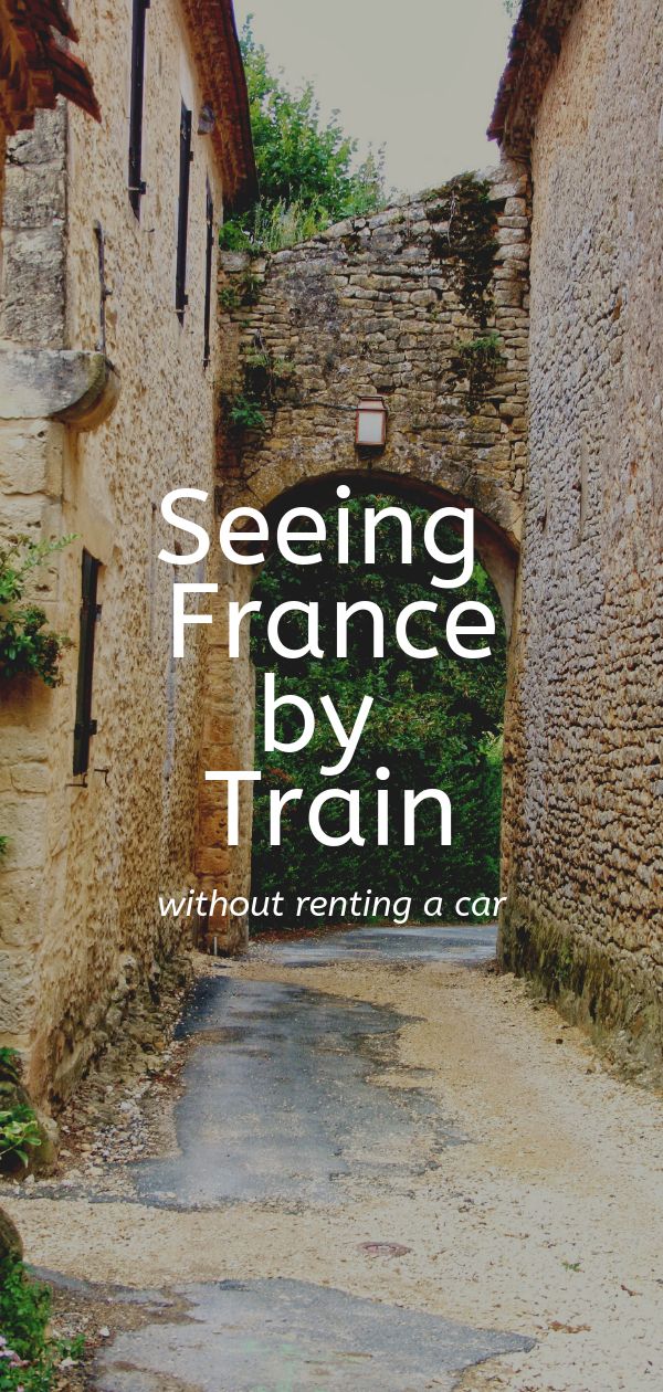 an alley way with the words seeing france by train written in white on it,