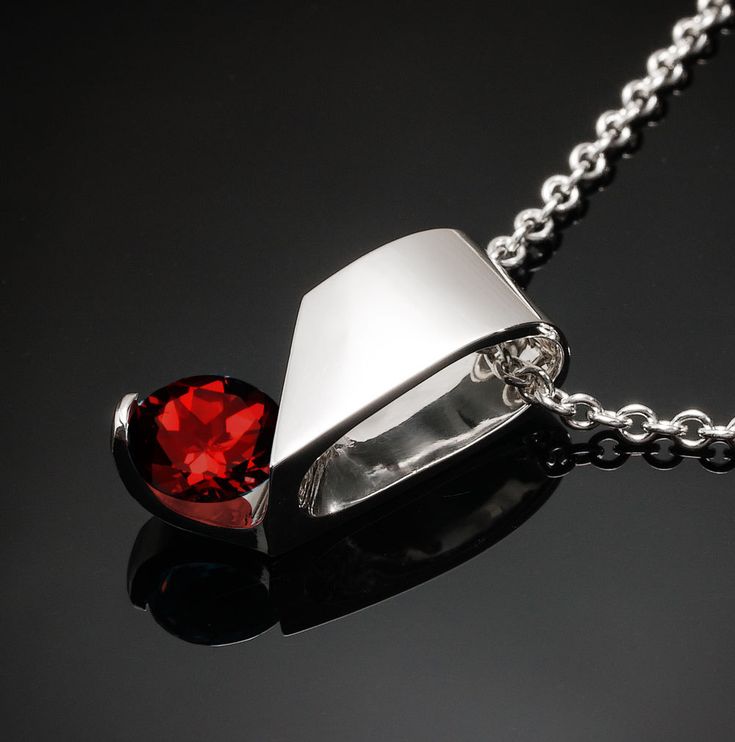 "Mozambique Garnet Necklace - Argentium Silver - 3460 - Argentium Chain Included A delicate pendant design with clean, contemporary lines. ( IMPORTANT - PLEASE READ 1. AND 2 BELOW ) 1.) INCLUDED IN THE PRICE IS AN ARGENTIUM SILVER CHAIN APPROPRIATE FOR THE PENDANT CHOSEN. YOU CAN CHOOSE FROM 16\", 18\" OR 20\" LENGTH AT CHECKOUT. 2.) PLEASE LOOK AT THE MEASUREMENTS CAREFULLY. SOME PHOTOS HAVE BEEN ENLARGED TO SHOW DETAIL, WHILE OTHERS HAVE BEEN MINIMIZED TO FIT THE FRAME. ACTUAL SIZE CANNOT BE D Yucca Valley, Delicate Pendant, Color Stones, Garnet Pendant, Garnet Necklace, January Birthstone, Argentium Silver, Jewelry For Her, Pendant Silver