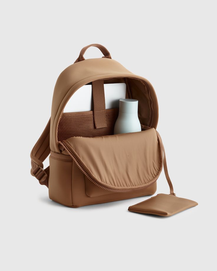 They say it’s all about work-life balance, right? That’s exactly what you’ll get in our All-Day Neoprene Backpack. With a built-in laptop sleeve, detachable pouch for valuables, and ample pockets to keep you organized, this backpack will be your go-to from 9-to-5 and beyond. Did we mention how much we’re loving the super flexible, recycled neoprene fabric and luggage-handle sleeve on the back? Trust us when we say this is the backpack you’ll use on the reg – whether you’re hitting the gym after Work Backpack Women, Neoprene Backpack, Commuter Backpack, Work Backpack, Day Backpacks, Diy Bags Patterns, Neoprene Fabric, Leather Jacket With Hood, Super Flexible