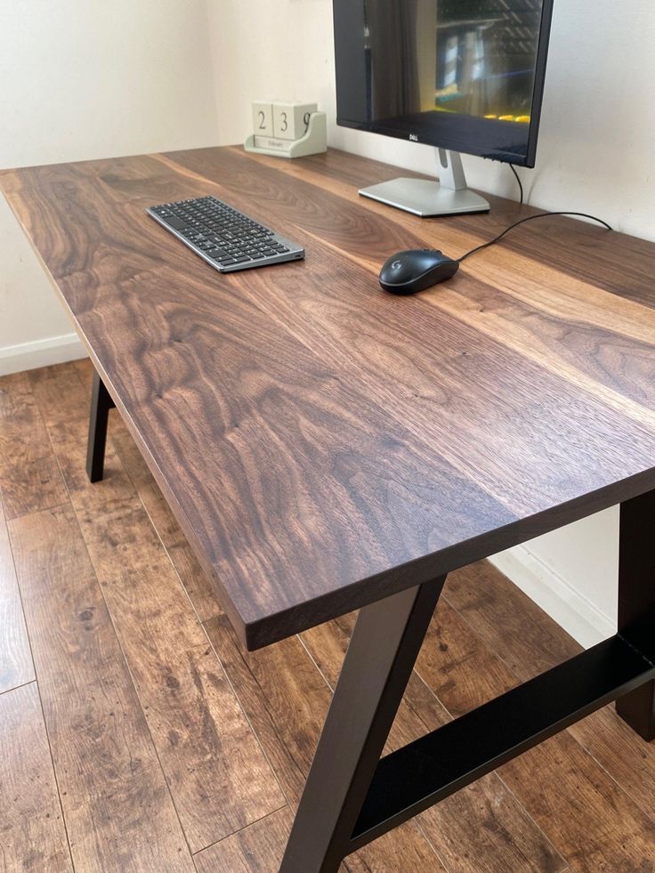 a computer desk with a keyboard, mouse and monitor sitting on it's side