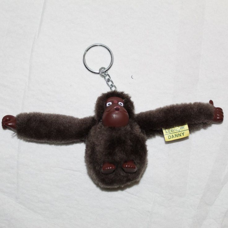 a stuffed animal keychain with a tag on it