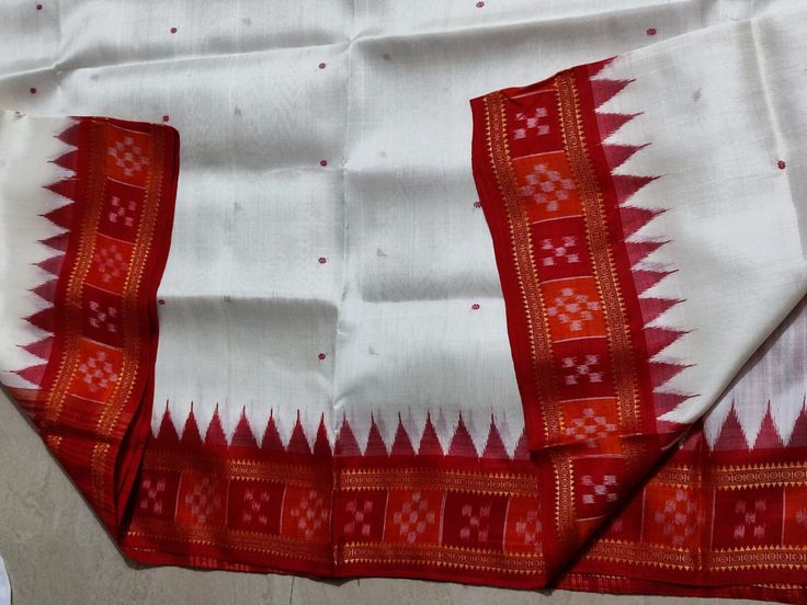 Elevate your Durga Puja celebrations with our exquisite White Sambalpuri Khandua Pata Handloom Silk Saree. Crafted with pure silk, this saree boasts a pristine white base adorned with a striking red border and pallu, embodying timeless elegance and grace. The intricate handloom weaving showcases the rich heritage of Sambalpuri craftsmanship, making it a perfect choice for the festive season. Embrace the traditional charm and vibrant spirit of Durga Puja with this luxurious saree, designed to mak Traditional Saree With Border For Celebration, Traditional Border Saree For Celebration, Traditional Celebration Saree With Border, White Art Silk Dupatta With Border, White Tussar Silk Dupatta For Celebration, Celebration White Tussar Silk Dupatta, White Paithani Silk Dupatta For Puja, White Handloom Saree For Celebration, Traditional Dupatta With Border For Celebrations