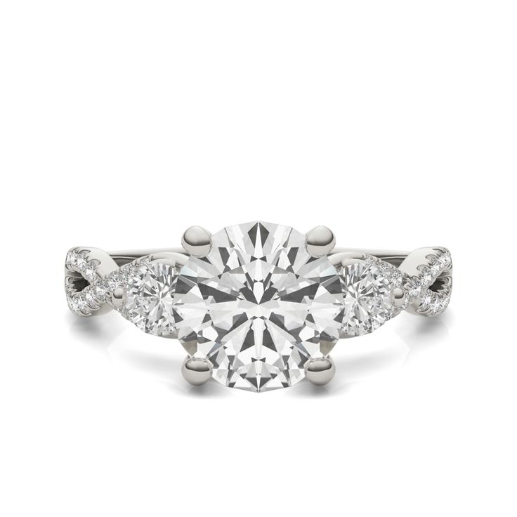 a diamond engagement ring with three stones on the band and an oval center stone in the middle