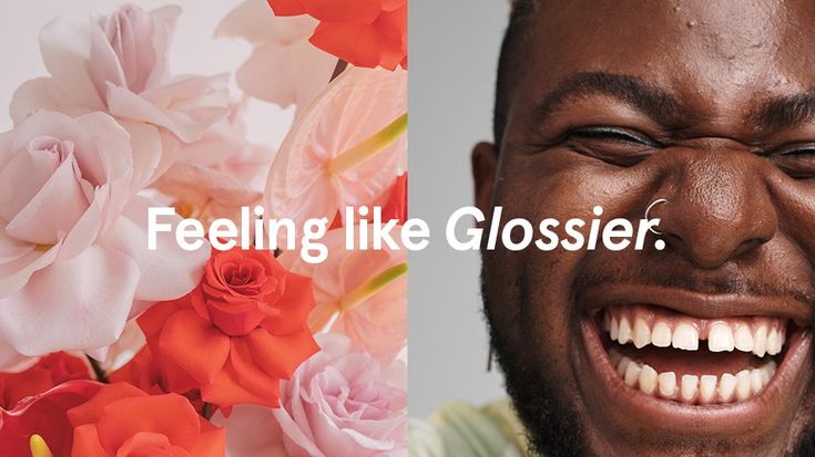 a man smiling with flowers in front of him and the words feeling like glossier