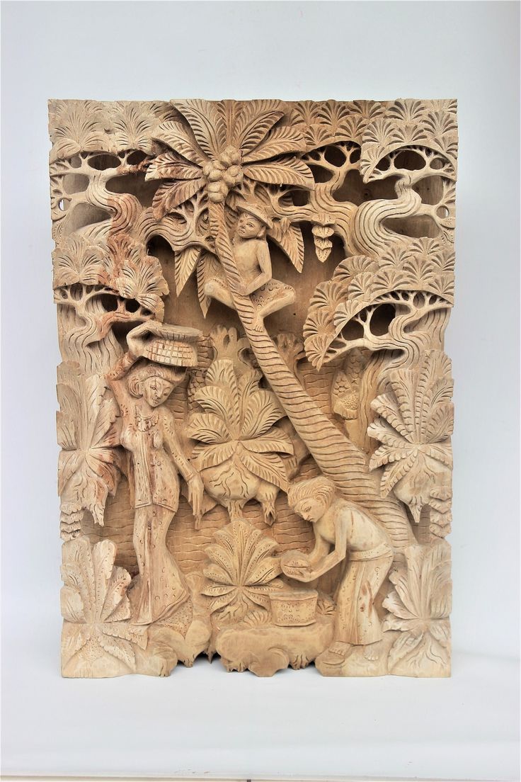 an intricately carved wooden panel with animals and trees