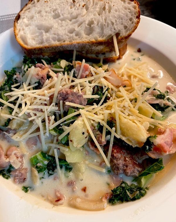 a white plate topped with meat, cheese and broccoli