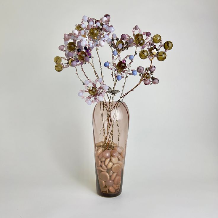 a vase filled with lots of flowers on top of a table