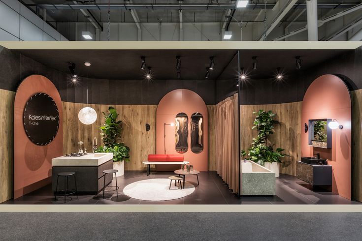 a show room filled with lots of furniture and plants on display in front of the camera