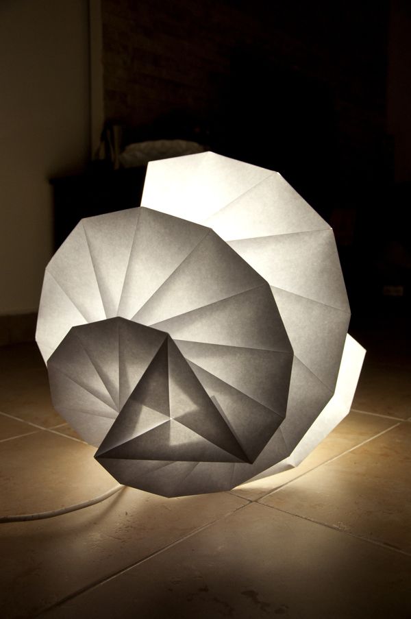 an origami sculpture sitting on top of a tile floor