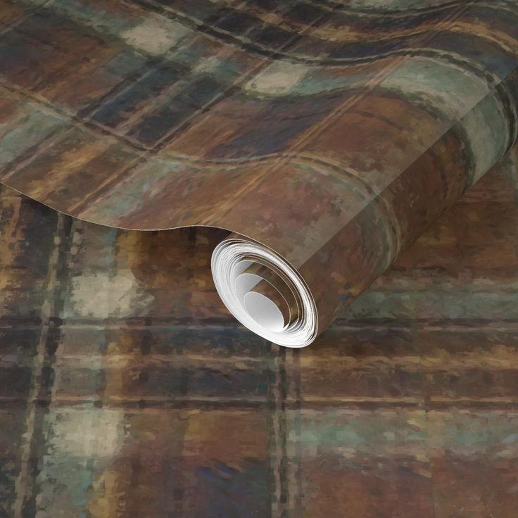 a close up view of a plaid wallpaper with a roll of paper on the floor