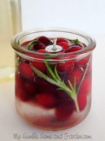 a jar filled with cherries sitting on top of a table