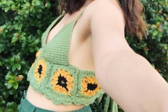 This sunflower crop top has a corset criss-cross tie in the back, allowing the top to fit perfectly to your body. This top is color customizable and perfect for summer! Cute Fitted Halter Top For Spring, Fitted Cute Halter Top For Spring, Fitted Summer Crop Top With Tie Back, Summer Fitted Crop Top With Tie Back, Green Crop Top Halter For Summer, Green Tie Back Crop Top For Spring, Fitted Summer Camisole Crop Top, Fitted Tie Back Summer Crop Top, Green Cropped Halter Top For Summer