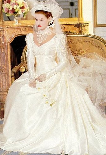 a woman in a wedding dress sitting on a chair