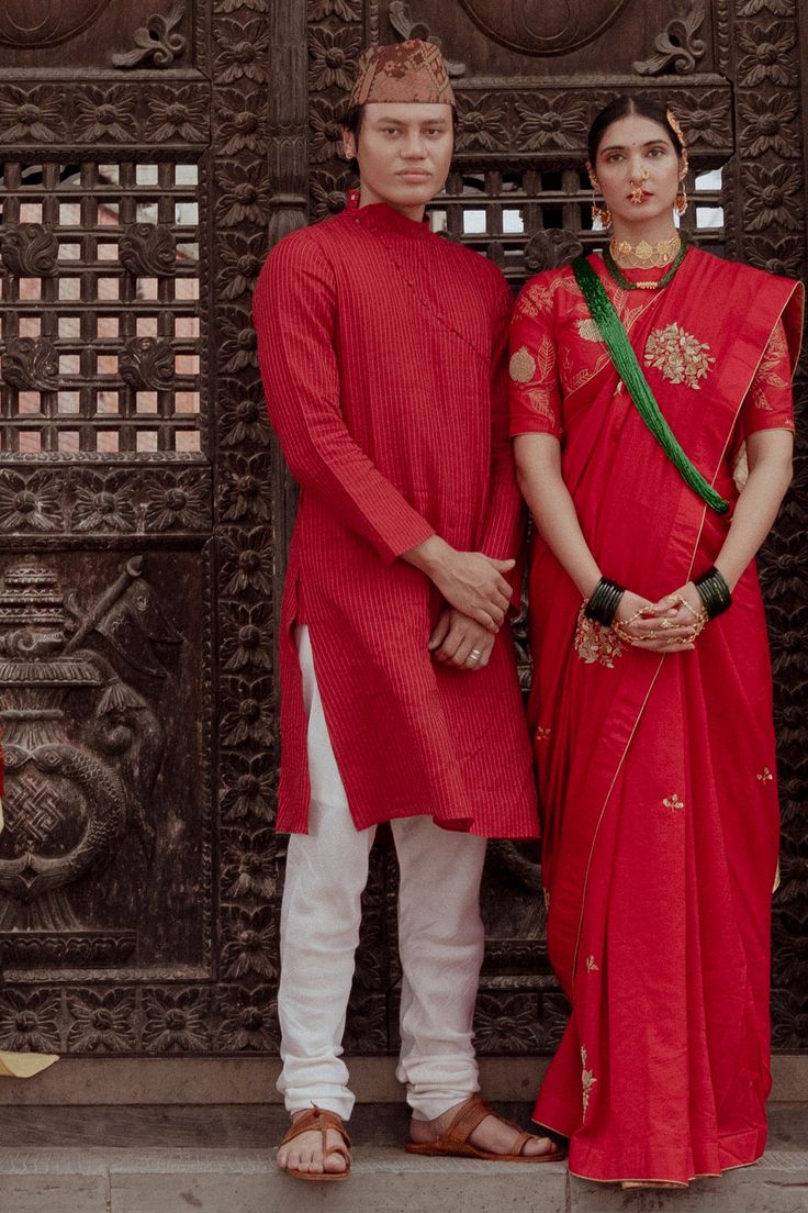 Maroon chanderi kurta with zari lines, high neck collar and asymmetric button placket. Paired with cotton nizam border fabric churidar.
Component: 2
Pattern: Woven
Type Of Work: Stripes
Neckline: High Neck Collar
Sleeve Type: Full Sleeves
Fabric: Kurta: Chanderi, Churidar: Cotton Nizam Border Fabric
Color: Maroon
Other Details: 
Note: The saree worn by  the female model is not for sale
Occasion: Sangeet,Mehendi and Puja - Aza Fashions Slub Silk Sherwani For Wedding With Traditional Drape, Wedding Sherwani In Slub Silk With Traditional Drape, Wedding Slub Silk Sherwani With Traditional Drape, Festive Cotton Silk Bandhgala With Traditional Drape, Slub Silk Kurta With Cutdana For Puja, Cotton Silk Straight Kurta For Puja, Cotton Silk Sherwani With Cutdana In Traditional Drape, Chanderi Sherwani For Traditional Ceremonies, Traditional Fitted Bandhgala For Puja