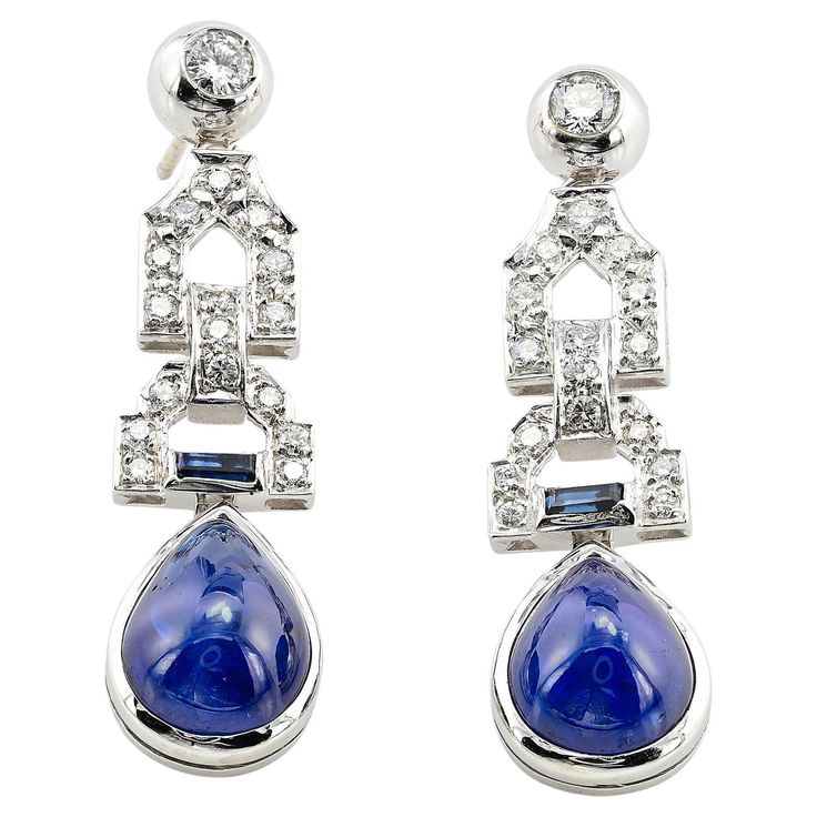 These superbly designed late Art Deco Diamond and Sapphire earrings are 1935/40 circa Exquisitely hand crafted during the period of solid 14 Kt white gold, marked The earrings prize a chic geometric design of eternal style set with natural earth mined gemstones between bright white Diamonds and natural unheated Sapphires creating charming and effect altogether The fantastic Blue suspending drops are two natural untreated/ unheated natural Sapphires of intense rich Blue color assessed by our specialist - approx 14.00 Ct for both deep and beautiful cabochon drop shaped measuring 12.5 x 9.8 mm The articulated top line  is set with 1.00 Ct of Diamonds rated G VVS/VS further enhanced by two small baguette Sapphire of .15 Ct adding lovely contrast contrast Fine condition commensurate to age and Late Art, Gem Jewelry, Diamond Drop Earrings, Diamond Drops, Art Deco Diamond, Sapphire Earrings, Natural Earth, Gems Jewelry, Natural Sapphire