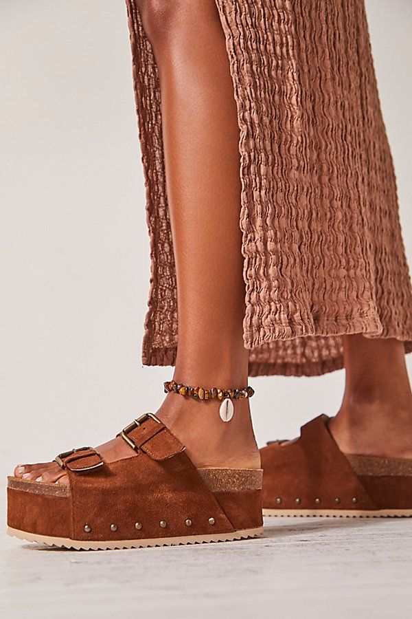 Turn heads in these so bold and statement-making sandals featured in a slip-on style and two-strap design with a chunky flatform sole, studded embellishments, and buckle detailing. * Open-toe design * Molded cork footbed * Wood hand carved base | Rule Breaker Flatform Sandals by Intentionally Blank at Free People in Brown, Size: EU 37 Making Sandals, Beach Flats, Teva Flatform, Birkenstock Madrid Big Buckle, Free People Sandals, Moon Earth, Intentionally Blank, Rule Breaker, Cork Sandals