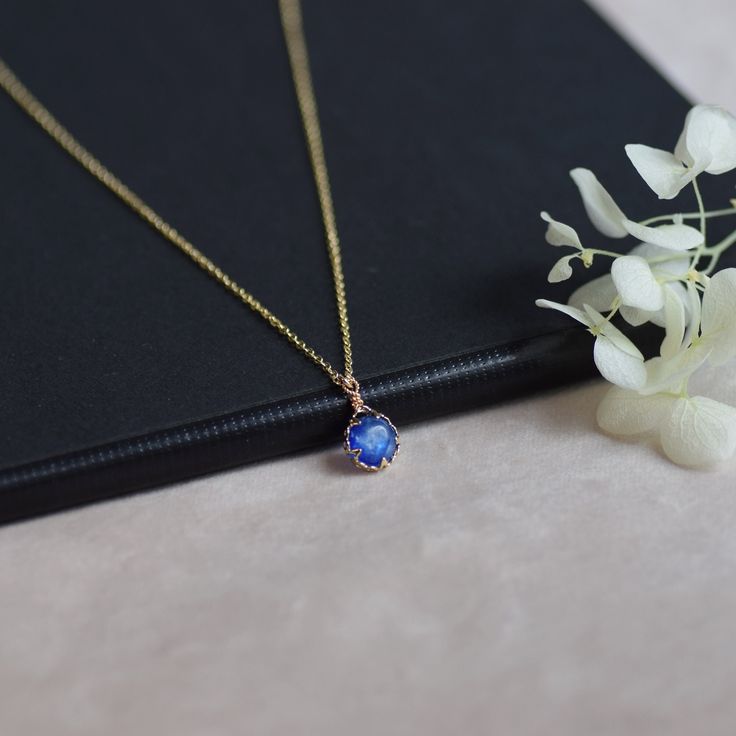 Handmade item Materials: 14k Gold Plated Gemstone: Kyanite  Jewelry type: Necklace Style:  Minimalist Description *Necklace Length : 14inches/16inches/18inches/20inches *Pendant Dimensions : 8mmX8mm Round/ 7mmX9mm Oval *Chain Thickness : 1.3mm 🌻Tips on Caring for Jewelry: - If you want your jewelry to look new at all times please take jewelry off before showering. - Please keep it away from chemicals, water, and high temperature, it can be too harsh for your stone. - Store it well. A ring box or airtight ziplock bag is the perfect place to keep them. Do not hesitate to contact me with any doubts, I will be happy to help you!  : ) CHECK MORE JEWELRY https://www.etsy.com/shop/CaitlinsJewelryHouse?ref=seller-platform-mcnav Thank you for visiting my shop! Round Crystal Necklace With Delicate Chain For Gift, Delicate Round Crystal Necklaces For Gift, Delicate Round Crystal Necklace For Gift, Gift Crystal Necklace With Delicate Chain, Handmade Sapphire Crystal Necklaces As Gift, Handmade Sapphire Crystal Necklace For Gift, Handmade Sapphire Crystal Necklace Gift, Minimalist Sapphire Birthstone Necklace For Gift, Sapphire Pendant Crystal Necklace For Gift