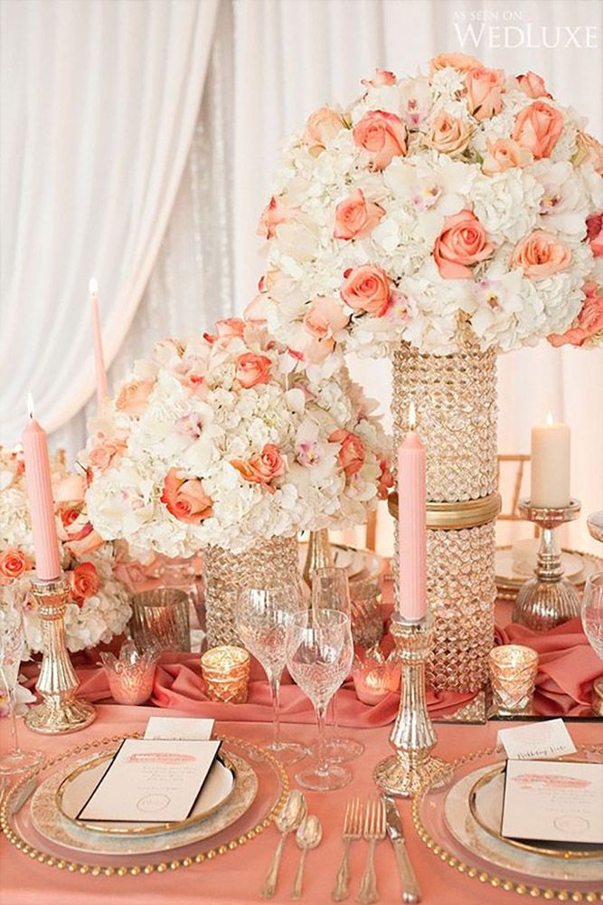 the table is set with pink and white flowers