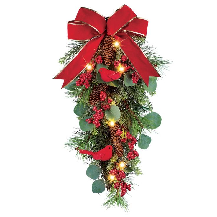 a christmas wreath with red bows and pine cones is adorned with greenery and lights