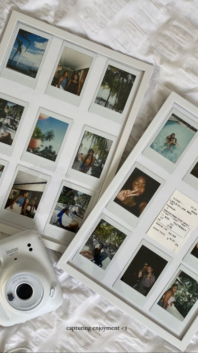 two polaroid cameras sitting on top of a bed next to pictures and an envelope