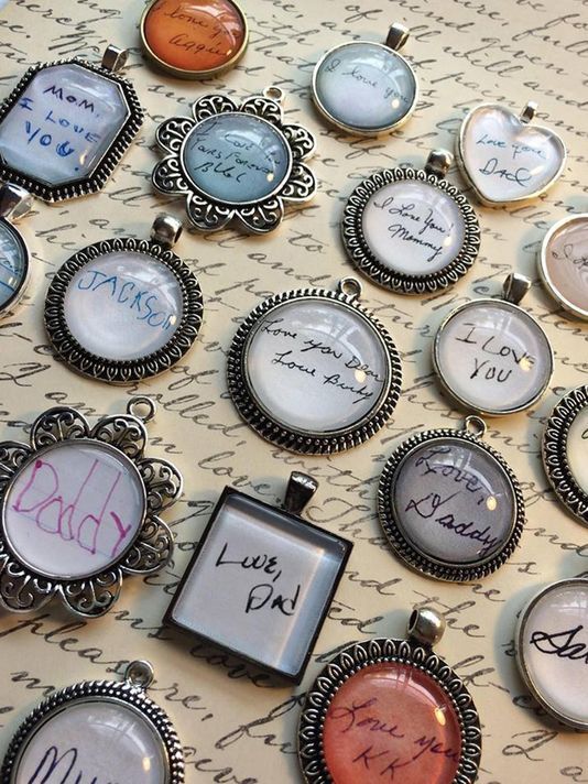 many different types of necklaces with writing on them and pictures attached to the backs