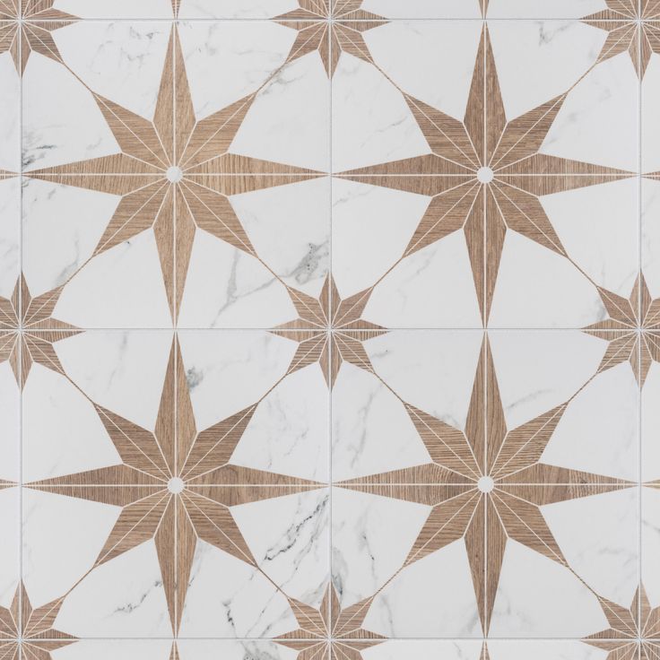 a white and brown tiled floor with star designs on the top, along with some gold accents