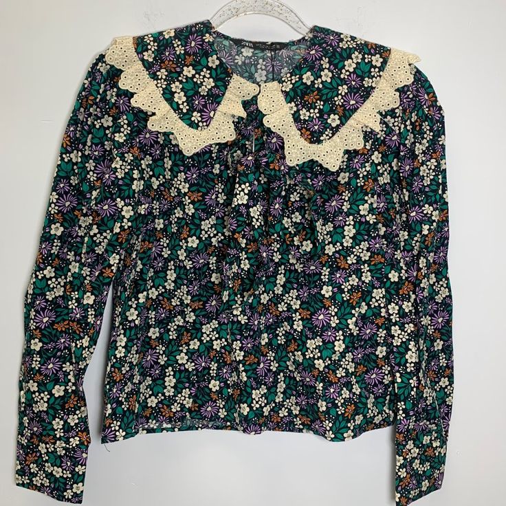 Size M Pit To Pit 19 Inch Nwt Zara Floral Printed Blouse With Ruffle And Lace Trim Adorable Floral Printed Blouse With Lace Trim Peter Pan Collar And Tie At Neck. Long Sleeves.Embroidery Cottagecore Cute Vintage Vibes 70s 90s 80s Preppy Work Office Fall Tops With Lace Trim And Ruffled Collar, Fitted Floral Print Top With Peter Pan Collar, Floral Print Tops With Peter Pan Collar For Daywear, Retro Blouse With Ruffled Collar, Green Fitted Blouse With Ruffled Collar, Green Long Sleeve Blouse With Lace Trim, Zara Floral Print Collared Blouse, Zara Collared Blouse With Floral Print, Retro Long Sleeve Blouse With Lace Collar