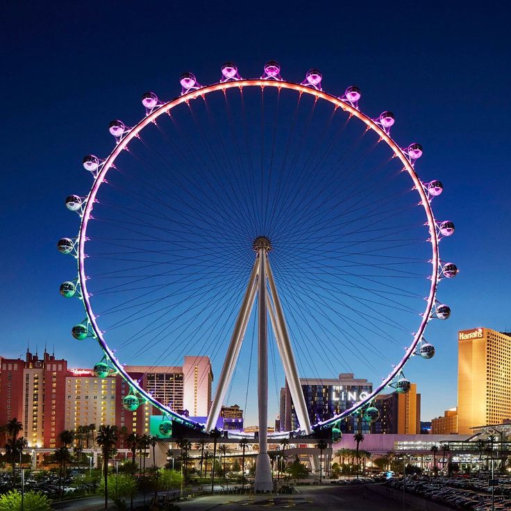 the ferris wheel is lit up at night