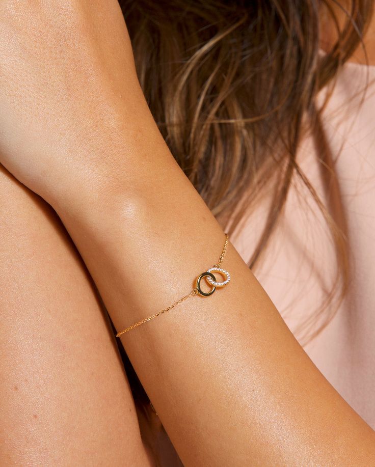 The prettiest mother/daughter, best friends, or sister bracelet you'll ever see! It makes the perfect gift for yourself and others. The chain is dainty and glistening, making it the perfect bracelet for a special occasion as well as everyday wear. Meaningful and stylish all in one! DETAILS: Model is wearing a 14k gold plated glistening bracelet with interlocking circles signifying infinity. *All bracelets are adjustable to fit multiple wrist widths. For a specific bracelet length just leave your Sister Bracelet Ideas, Friendship Infinity Bracelets For Mother's Day, Adjustable Chain Jewelry For Mother's Day Friendship, Adjustable Chain Name Bracelet For Friendship, Elegant Infinity Bracelet For Best Friend, Adjustable Infinity Jewelry For Best Friend Gift, Minimalist Accessories Jewellery, Delicate Gold Bracelet, Daughter Bracelet