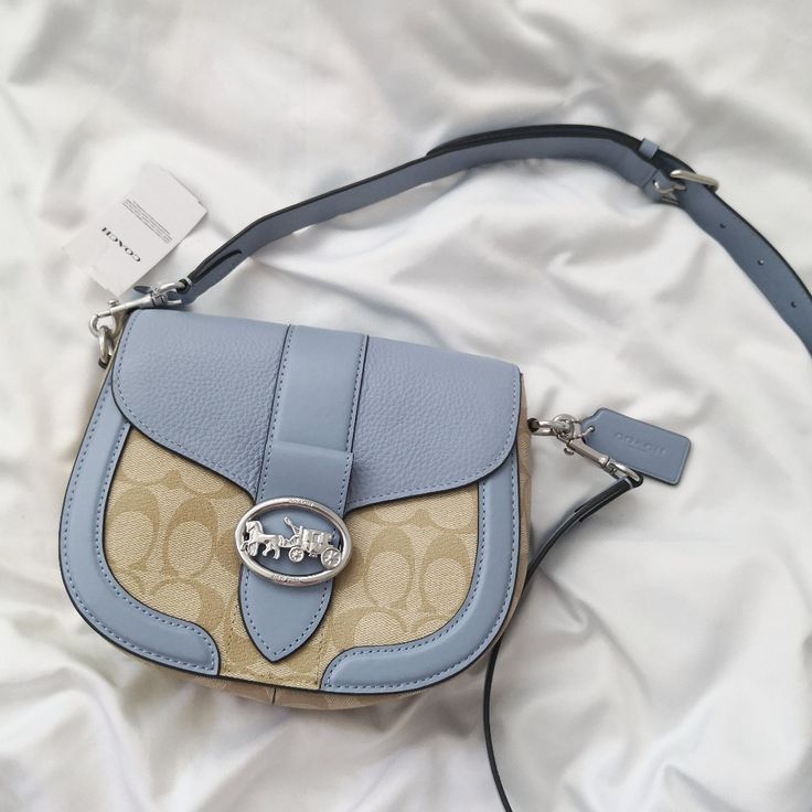 New Coach Georgie Saddle Bag In Signature Canvas C2806 Light Khaki/Marble Blue $350 Signature Coated Canvas, Smooth Leather And Refined Pebble Leather Inside Multifunction Pockets Snap Closure, Fabric Lining Outside Open Pocket Detachable Strap With 20 3/4" Drop For Shoulder Or Crossbody Wear 8 1/4" (L) X 6 3/4" (H) X 2 3/4" (W) Designer Light Blue Bag With Detachable Strap, Designer Light Blue Bags With Detachable Strap, Blue Coated Canvas Top Handle Shoulder Bag, Blue Crossbody Saddle Bag For Daily Use, Designer Light Blue Bag With Gold-tone Hardware, Blue Coated Canvas Satchel Bag, Blue Crossbody Saddle Bag With Detachable Strap, Blue Luxury Leather Saddle Bag, Luxury Blue Leather Saddle Bag