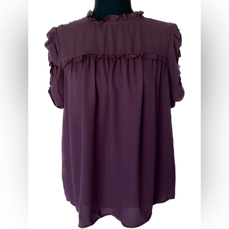 A Maroon Purple Short Sleeve Blouse From Who Wore What. Ruffle Mock Neck With Button Closure In Back. Ruffle Puff Sleeves. Size Small Great Condition, Never Worn Fall Short Sleeve Ruffle Blouse, Fall Blouse With Ruffles And Short Sleeves, Fall Ruffled Short Sleeve Blouse, Fall Ruffles Short Sleeve Blouse, Purple Ruffled Collar Blouse With Ruffles, Chic Purple Puff Sleeve Blouse, Purple Ruffle Puff Sleeve Tops, Purple Puff Sleeve Top With Ruffles, Purple Tops With Ruffles And Ruffled Collar