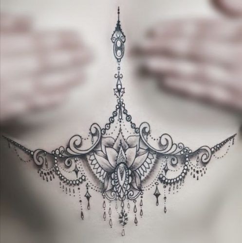 a woman's chest with an intricate design on it