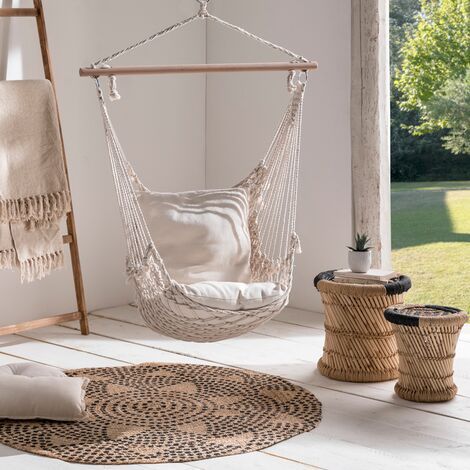 a hammock hanging from the ceiling in a room with white walls and flooring