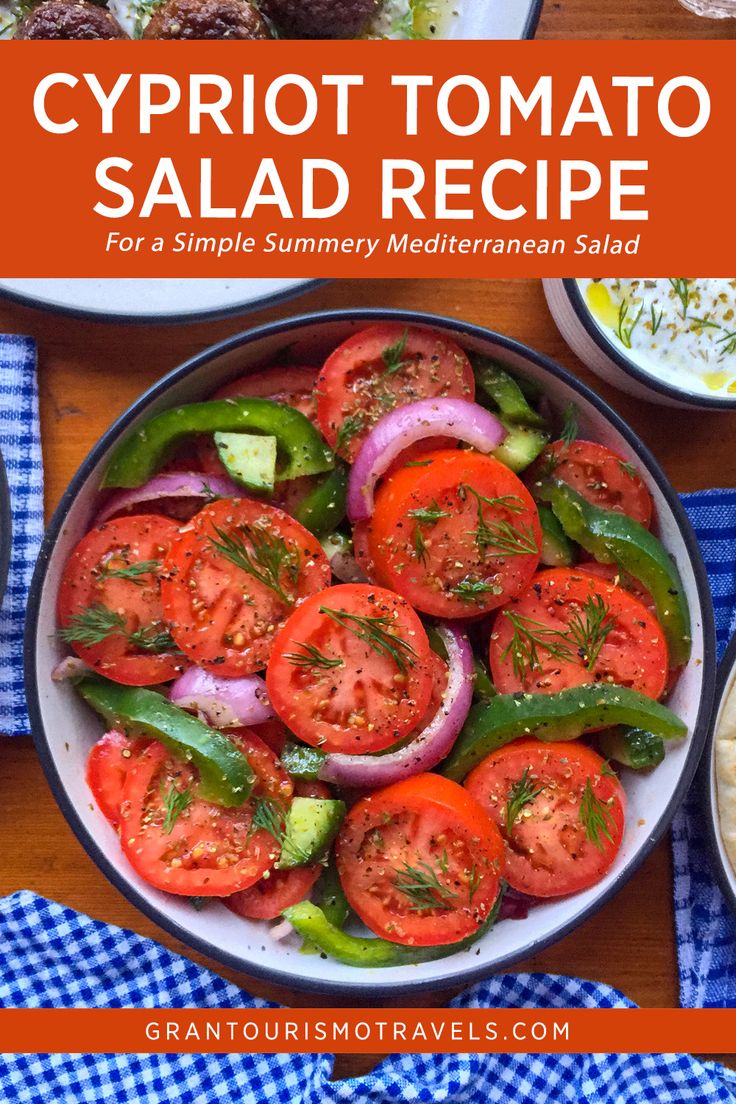 a bowl filled with sliced tomatoes, onions and cucumber on top of a blue checkered table cloth