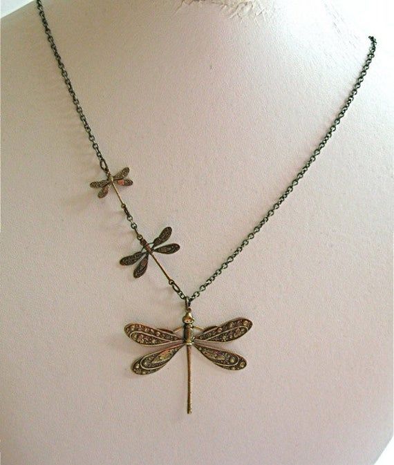 "Brass Dragonfly Necklace - Three Ornate Antiqued Brass Dragonflies in three different sizes, on an Antiqued Brass Chain. The large dragonfly is slightly over 1.5\" high x 2\" wide, the medium dragonfly is just under 1\" high x 1\" wide, and the smallest dragonfly is just under .75\" high x .75\" wide. These are stampings. The design is on one side. 20\" Length This necklace is also available in other metal finishes: http://www.etsy.com/shop/mcstoneworks/search?search_query=triple+dragonfly& Woman Birthday, Dragonfly Gifts, Jewelry Nature, Dragonfly Jewelry, Estilo Hippie, Dragonfly Necklace, Mia 3, Dope Jewelry, I'm With The Band