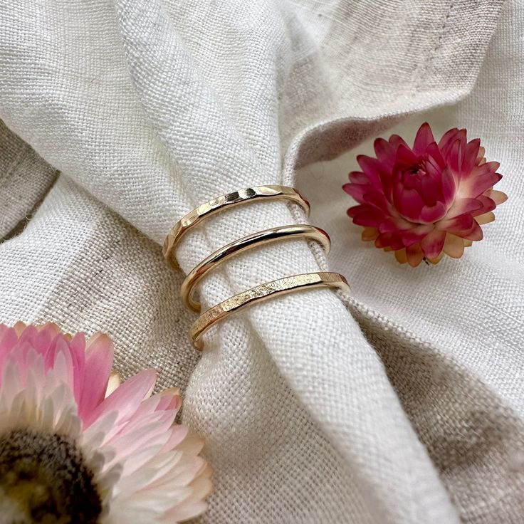 materials:•yellow 14K Gold size & styles:•Smooth: 1.6mm•Textured: 1.8mm•Hammered: 1.8mmSee the minimalist version of these bands hereSee the thicker version of these bands heregold guarantee:•14K Gold will not tarnish•heirloom quality, this piece will last lifetimes•it is a great metal for sensitive skin•your order will qualify for complimentary tracked + express shipping•all solid 14K orders will require a signature upon deliveryFollow along @openfirejewellery.Handmade in Canada using quality materials.Carefully made & intentionally designed for long term wear. Everyday Hammered Recycled Gold Rings, Minimalist Hand Forged Gold Midi Rings, Hammered 14k Gold Jewelry, Hammered Yellow Gold Rings For Everyday, Hammered 14k Gold Band Jewelry, Hammered 14k Gold Round Band Jewelry, Dainty Stackable Rings In Recycled Gold Stamped 14k, Tarnish Resistant Rose Gold Stackable Rings In Recycled Gold, Classic Hammered 14k Gold Stackable Rings