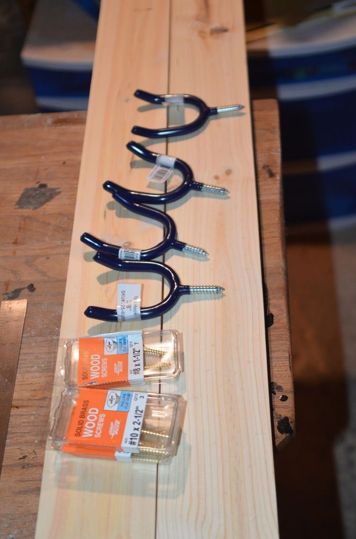 several pairs of scissors are sitting on a piece of wood with screwdrivers attached to them