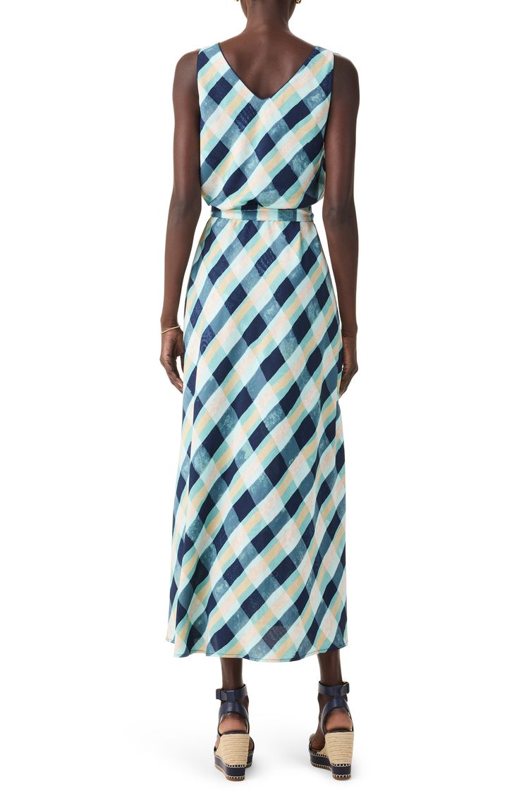 Move gracefully in this sleeveless dress designed in an eye-catching plaid print and tethered with a defining waist tie. 48" length Slips on over head Scoop neck Sleeveless Removable tie belt Lined 100% polyester Machine wash, tumble dry Imported Chic Sleeveless Plaid Dress For Picnic, Sleeveless Plaid Dress For Picnic, Plaid Sleeveless Dress For Picnic, Plaid Maxi Dress For Summer Beach, Sleeveless Plaid Dress For Spring, Plaid Sundress For Vacation, Chic Plaid Dress For The Beach, Chic Summer Plaid Maxi Dress, Chic Gingham Sleeveless Dress