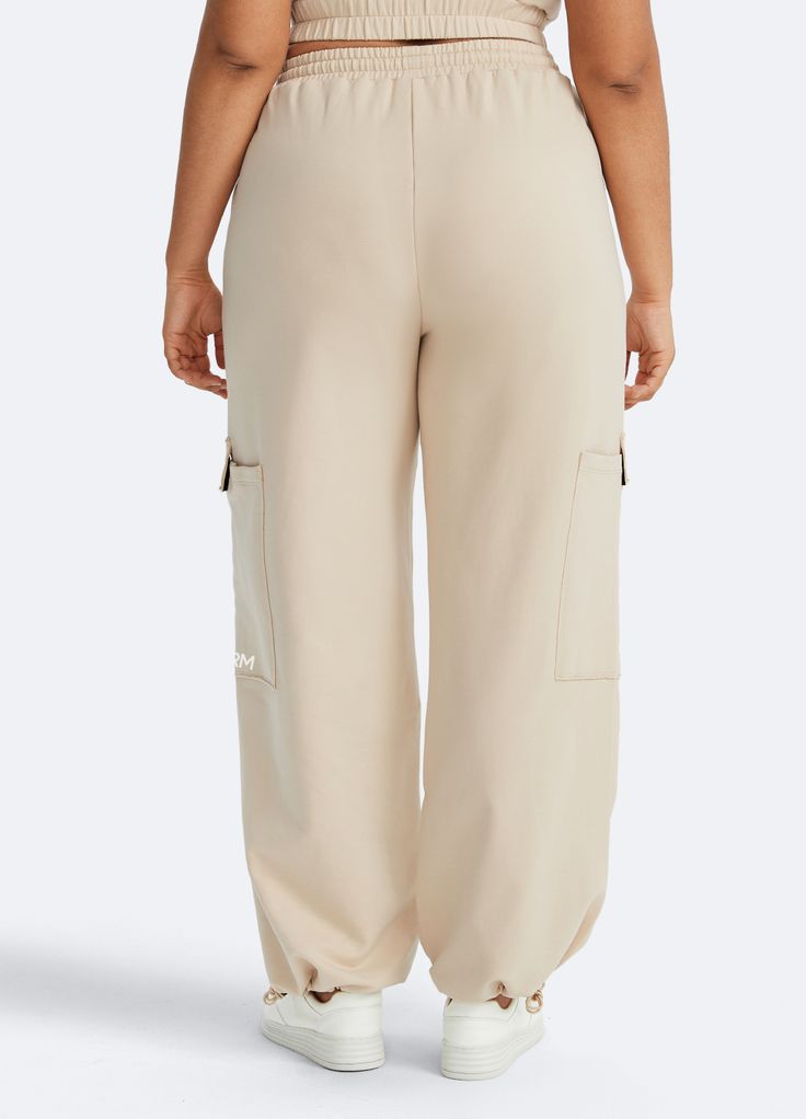 Embrace roomy wide legs and a stretchy fit for ultimate comfort, paired with a flattering high waist for added style. Whether it's grocery runs, lazy Sundays, or a casual hangout, these joggers have you covered in relaxed elegance. Full-length Beige Athleisure Pants, Beige Full-length Bottoms With Pockets, Cream Wide-leg Sweatpants With Elastic Waistband, Beige Full-length Bottoms With Elastic Waistband, Beige High-waist Parachute Pants With Elastic Waistband, Sweatpants For Women, Dance Leggings, Relaxed Elegance, High Neck Bodysuit