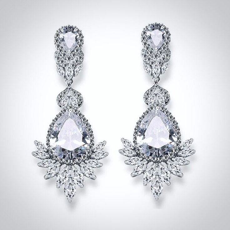 An exquisite bridal earrings design that will add a touch of sophistication to any wedding gown or formal ensemble. Adorned with flawlessly faceted cubic zirconia that capture the light in a dazzling array of sparkles, the earrings are rhodium / rose gold plated for a bright finish which enhances the intricate detailing and conveys a modern take on old elegance. Length: 2.3" (approx. 6cm; Width: 0.9" (approx. 2.4cm); Weight: 7.8g. Available in Silver and Rose Gold finishes. To make your choice s Dazzling Cubic Zirconia Bridal Earrings, Glamorous Cubic Zirconia Bridal Earrings For Formal Occasions, Dazzling Bridal Drop Earrings With Sparkling Stones, Elegant Diamond White Crystal Earrings, Formal Diamond White Chandelier Earrings For Pierced Ears, Exquisite Diamond White Crystal Earrings, Dazzling Cubic Zirconia Dangle Bridal Earrings, Dazzling Diamond White Crystal Bridal Earrings, Dazzling Crystal Bridal Earrings With Elegant Design