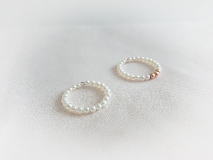 This gorgeous  delicate pearl ring is made with premium crystal pearls in white. This listing is for one ring with crystal pearls and sterling silver beads/ gold filled bead or rose gold filled beads. it is great for stacking with other rings. Dimensions: pearl size : 3mm round pearls Sterling silver Beads : 3mm  Gold filled Beads : 3mm Rose Gold Beads: 3mm " Please select your ring size when you checkout " Minimalist Adjustable Ring With Pearl Drop, Minimalist Adjustable Rings With Pearl Drop, Minimalist Adjustable Pearl Drop Rings, Minimalist Adjustable Pearl Rings, Minimalist Pearl Drop Ring For Gift, Minimalist Pearl Drop Rings As Gift, Delicate Stackable White Gold Pearl Ring, Delicate White Gold Stackable Pearl Ring, Minimalist Adjustable Pearl Ring With Charm