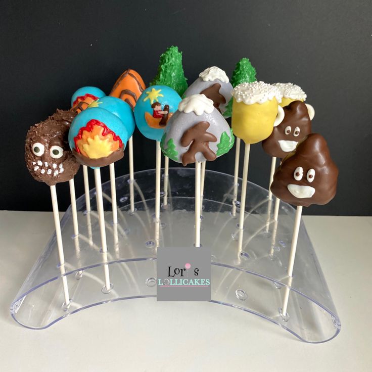 there are many cake pops that have faces on them in the shape of animals and trees