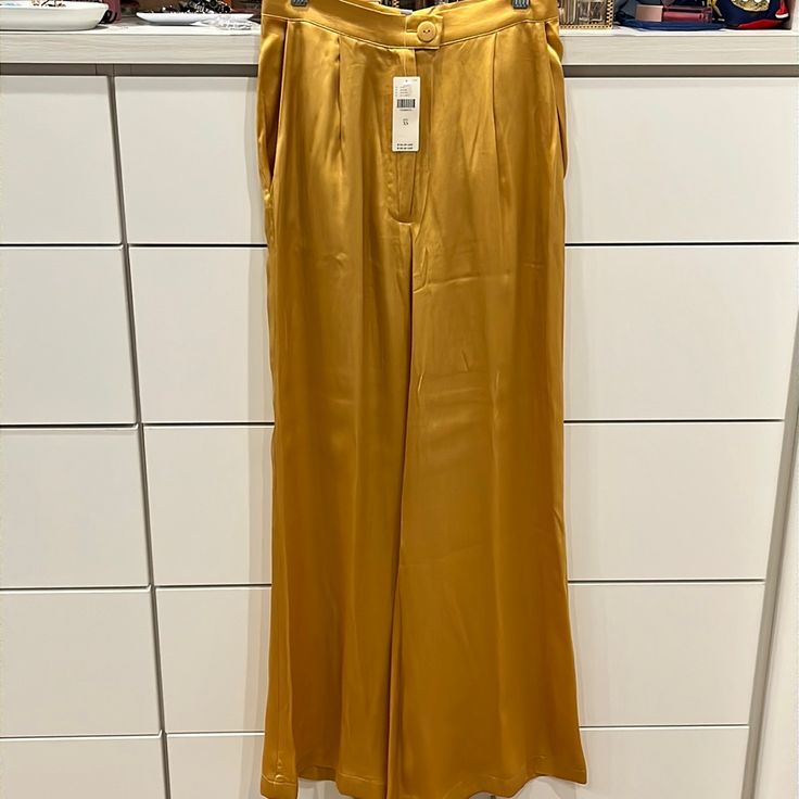 Bnwt Anthropologie Satin High Waisted Pants, Mustard/Gold Hue, Xs - Gorgeous High Waisted Pants With 1 Pleat On Each Side And Discreet Side Pockets For That Elegant Touch - Original Tags Are Still On (Included In Pics) As The Event I Bought These For Got Cancelled - These Paints Would Pair Beautifully With Any Type Of Shoe And Are Fall Forward Or Summer Ready! Elegant Yellow Party Bottoms, Chic Yellow Full-length Bottoms, Elegant Fitted Yellow Bottoms, Chic Yellow Wide Leg Bottoms, Yellow Wide Leg Full Length Pants For Spring, Yellow Wide-leg Workwear Pants, Gold Wide Leg Bottoms For Workwear, Fitted Yellow Wide Leg Pants For Spring, Chic Yellow Long Pants