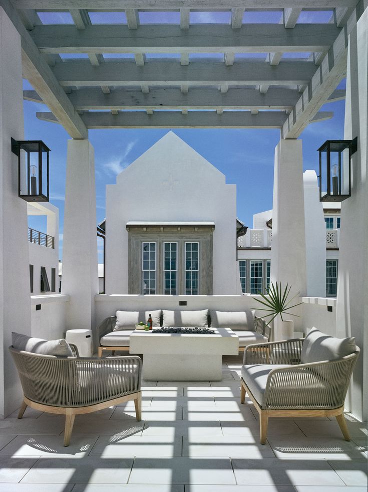 an outdoor living area with couches and chairs