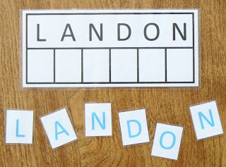 the word landon spelled out with cut outs on a wooden surface next to a pair of scissors