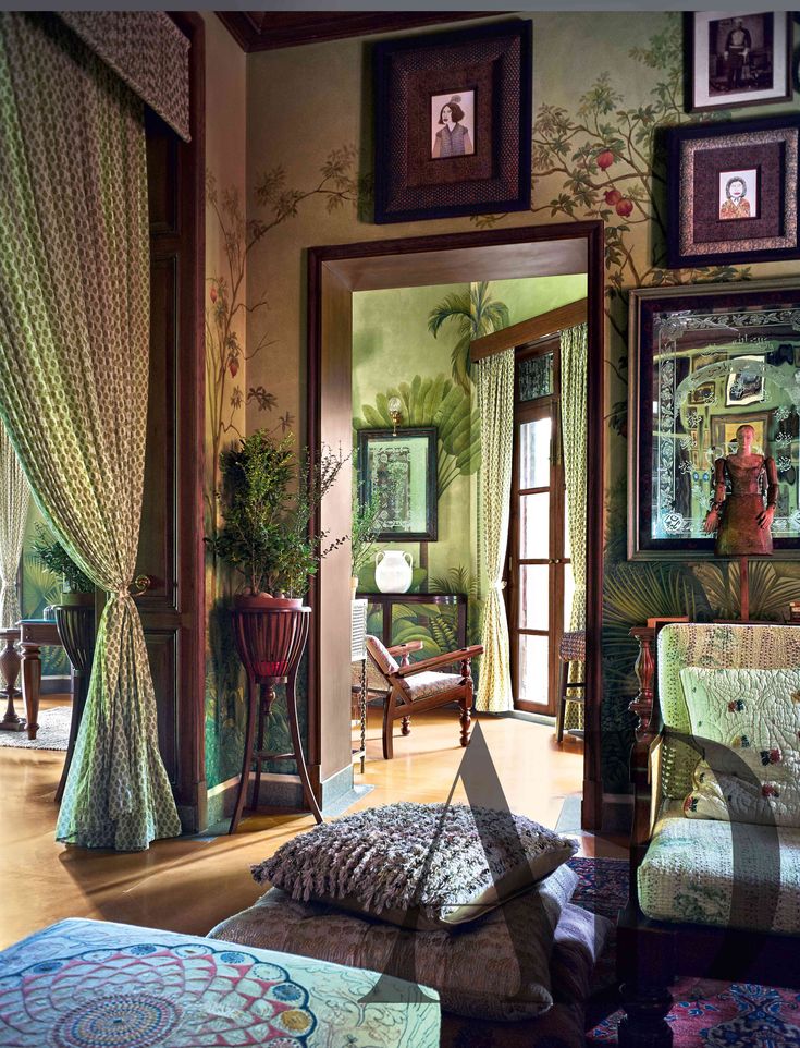 an ornate bedroom with green walls and paintings on the wall, along with matching bedding