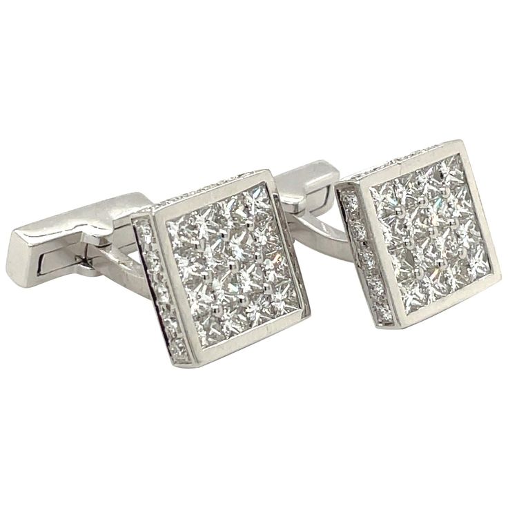 Magnificent pair of 18 karat white gold square diamond cuff links. The cuff links are invisibly set with princess cut diamonds. The entire border of the cuff links are set with round brilliant diamonds. The collapsible bar backs are also set with a row of princess cut diamonds. The cuff links measure 12.6 mm. Princess cut diamonds 4.65 carats Brilliant cut diamonds 1.00 carats Stamped 750 Classic Diamond Cufflinks With Polished Finish, Luxury Diamond Cufflinks With Polished Finish, Luxury Silver Diamond Cufflinks, Classic Diamond Cufflinks For Anniversary, Formal Diamond Cufflinks With Polished Finish, Diamond Cufflinks With Polished Finish For Formal Events, Elegant White Gold Cufflinks For Anniversary, Classic White Gold Diamond Cufflinks, Luxury Diamond Cufflinks