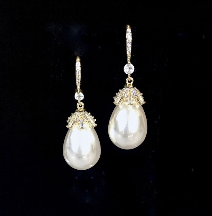 Best of both worlds! Iridescent pearls and clear cubic zirconia that capture the light from every angle with a perfectly translucent appeal come together to create a classy, sparkly and elegant pair of bridal earrings. The settings are gold / rhodium plated for a bright finish which enhances the intricate detailing and conveys a modern take on old elegance. Overall length of the earring is 1.5" (approx. 3.8cm). Width: 0.4" (approx. 1.2cm). Weight: 6g. Available in Yellow Gold and Silver with Whi Pearl Bridal Earrings, Iridescent Pearl, Bridal Earrings Pearl, Pearl Bridal, Bridal Pearls, Pearl Color, Gold Pearl, Bohemian Jewelry, Bridal Earrings